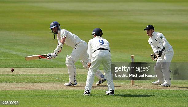 Mark Chilton of Lancashire hits out as Jonathan Trott and Timothy Ambrose look on during the LV County Championship match between Warwickshire and...