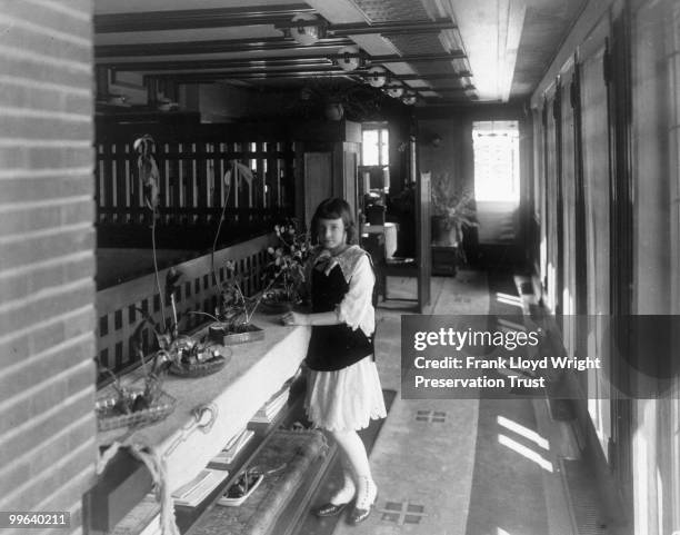 South hall looking east with Jeannette Wilber next to built-n shelving, Chicago, Illinois, 1916.