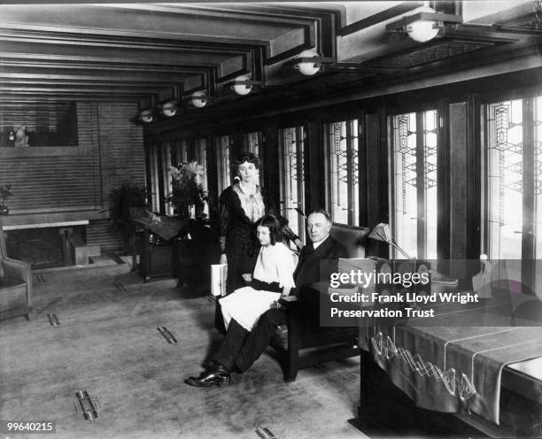 Wilber family in Living Room looking southeast with original library table, chairs, and art glass, Chicago, Illinois, 1916.