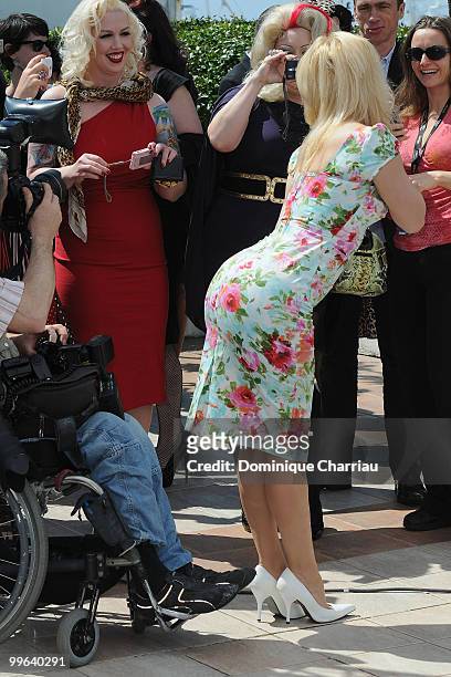 Actresses Mimi Le Meaux and Dirty Martini take a picture of actress Julie Atlas Muz attends the 'On Tour' Photocall held at the Palais Des Festivals...