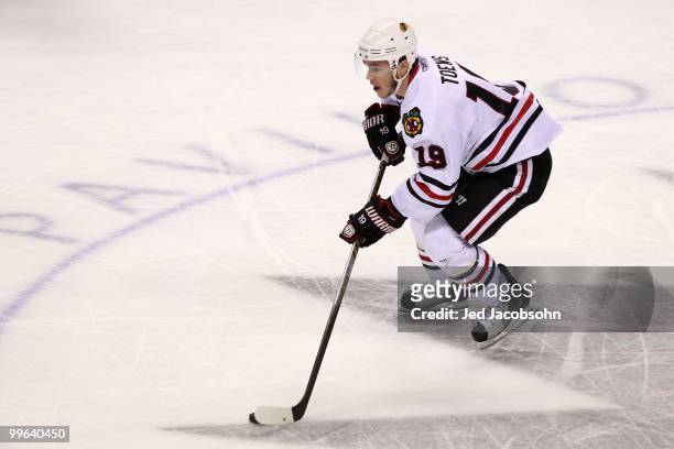Jonathan Toews of the Chicago Blackhawks moves the puck while taking on the San Jose Sharks in Game One of the Western Conference Finals during the...