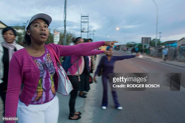 Commuters wait in Khayelitsha, in unusually long queues, for buses and mini-bus taxis, to take them to work after a strike by rail workers stopped...