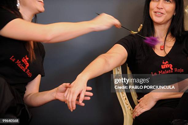 Gabriela Perez and Nicole Komin, representatives for Latin America of "La Maleta Roja" company, promote sex toys in Montevideo, Uruguay, on May 15,...