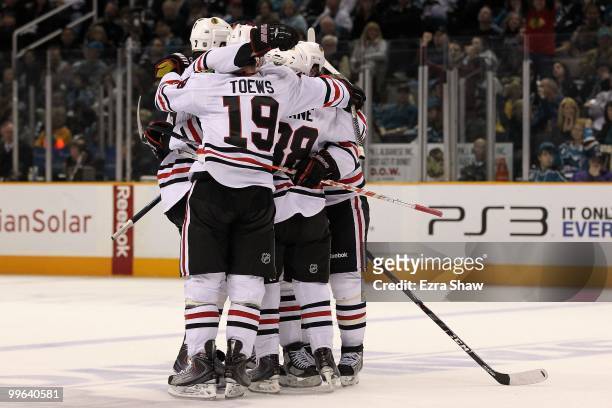 Dustin Byfuglien of the Chicago Blackhawks reacts with teammates after his third period goal against the San Jose Sharks in Game One of the Western...