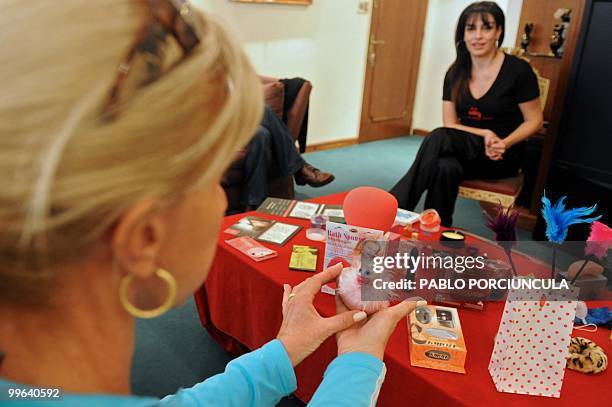 Woman looks at products of "La Maleta Roja" company, in Montevideo, Uruguay, on May 15, 2010. The Spanish company, specializing in erotic toys,...