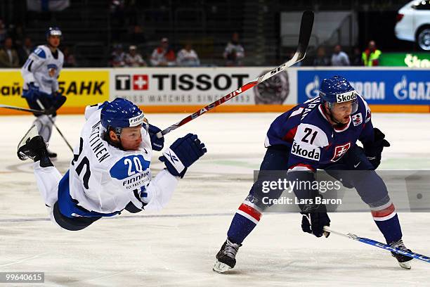 Antti Miettinen of Finland is challenged by Marek Zagrapan of Slovakia during the IIHF World Championship qualification round match between Finland...