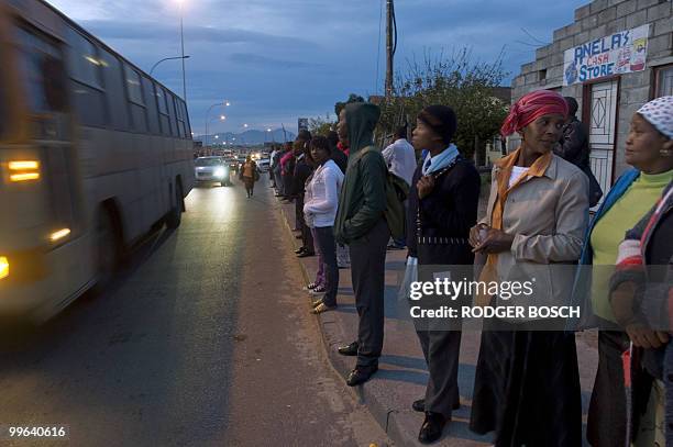 Commuters wait in Khayelitsha, in unusually long queues, for busses and mini-bus taxis, to take them to work after a strike by rail workers stopped...