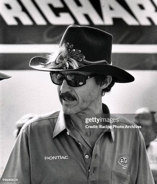 Richard Petty walks through the pits during the time trials of the Miller High Life 400. Petty would blow his clutch on the 76th lap and take home...