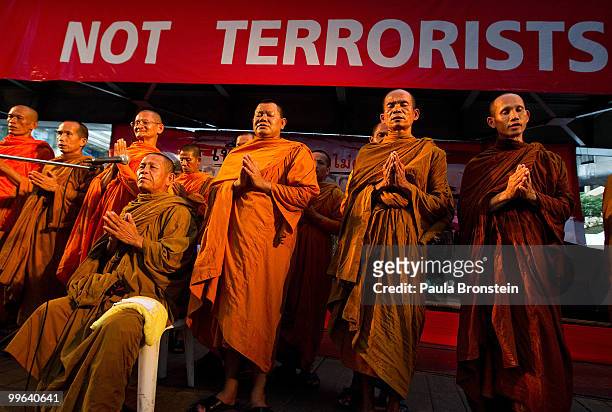 Thai monks lead a prayer with Red shirt protesters inside the Rachprasong red's encampment as the government deadline passes for the remaining...