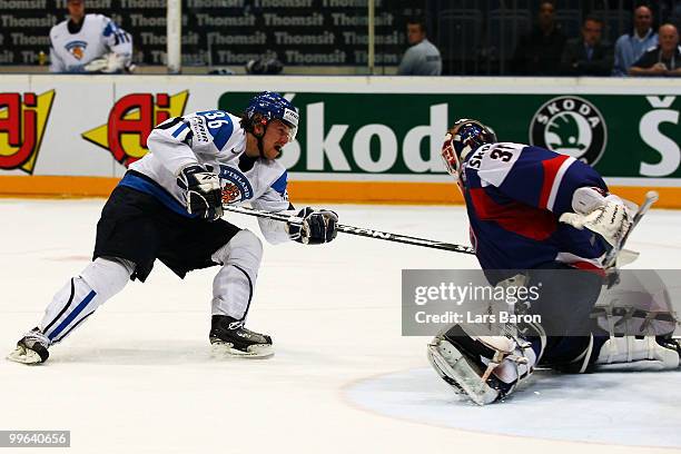 Jussi Jokinen of Finland scores his teams third goal past goalie Peter Budaj of Slovakia during the IIHF World Championship qualification round match...