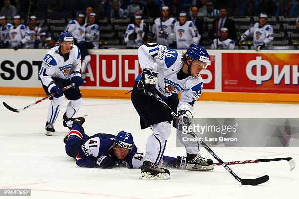 Richard Lintner of Slovakia challenges Jussi Jokinen of Finland during the IIHF World Championship qualification round match between Finland and...