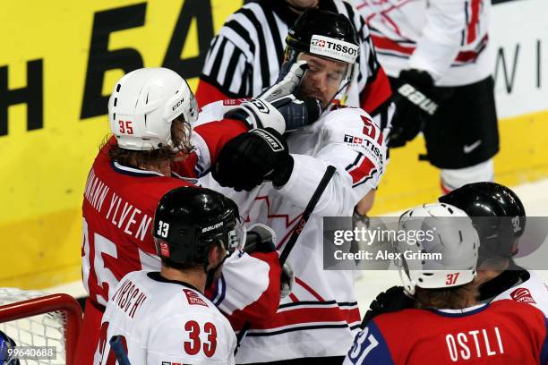 Martin Laumann Ylven of Norway fights with Goran Bezina of Switzerland during the IIHF World Championship group F qualification round match between...