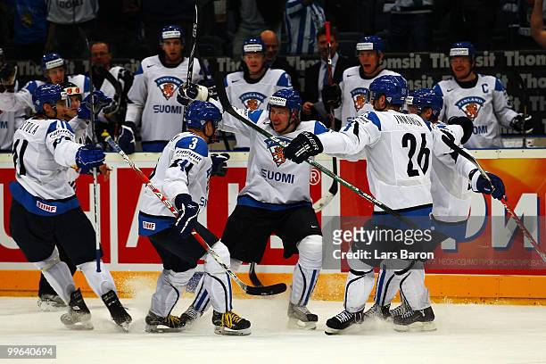 Jussi Jokinen of Finland celebrates with team mates after scoring his teams third goal during the IIHF World Championship qualification round match...