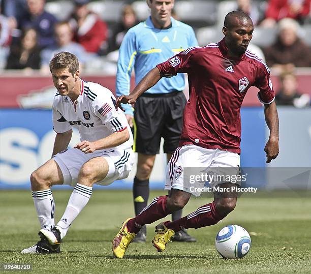 Omar Cummings of the Colorado Rapids takes the ball away from Logan Pause of the Chicago Fire during the first half at Dick's Sporting Goods Park in...