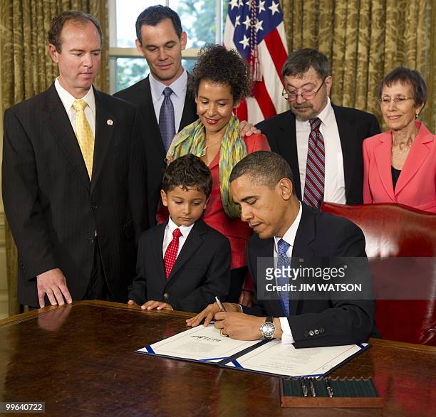 Mariane Pearl and Adam Daniel Pearl watch as US President Barack Obama signs the Freedom of the Press Act in the Oval Office of the White House in...