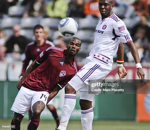 Omar Cummings of the Colorado Rapid and Kwame Watson-Siriboe of the Chicago Fire nearly collide while pursuing a loose ball during the first half at...