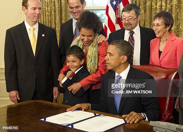 Mariane Pearl and Adam Daniel Pearl watch as US President Barack Obama signs the Freedom of the Press Act in the Oval Office of the White House in...