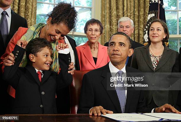 Mariane Pearl and son Adam Daniel Pearl react after President Barack Obama signed the Daniel Pearl Freedom of Press Act, on May 17, 2010 in...