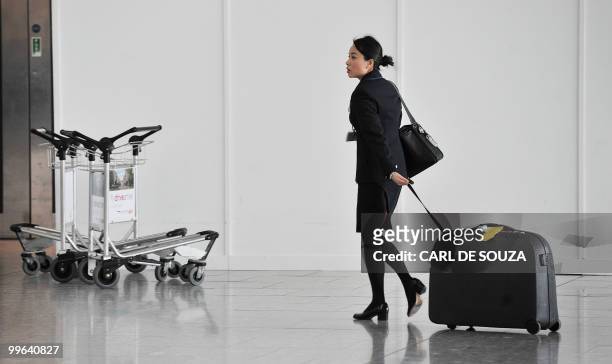 British Airways employee walks inside Heathrow Airport in London, on May 17, 2010. Britain's conciliation service Acas said it would broker talks...