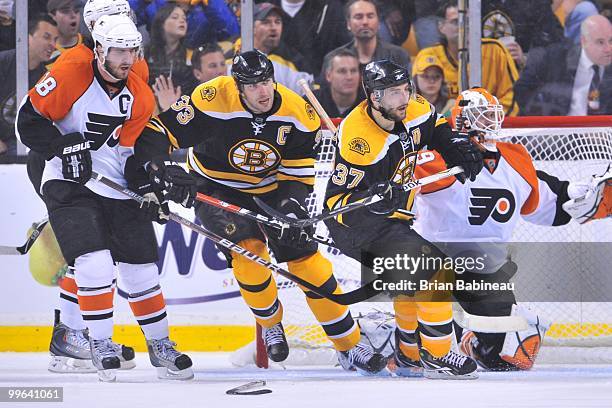 Zdeno Chara and Patrice Bergeron of the Boston Bruins watch the play against the Philadelphia Flyers in Game Seven of the Eastern Conference...