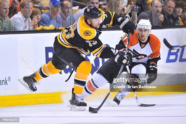 Michael Ryder of the Boston Bruins passes the puck against Blair Betts of the Philadelphia Flyers in Game Seven of the Eastern Conference Semifinals...