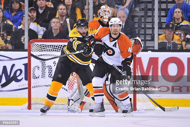 Patrice Bergeron of the Boston Bruins pushes Kimmo Timonen of the Philadelphia Flyers in Game Seven of the Eastern Conference Semifinals during the...