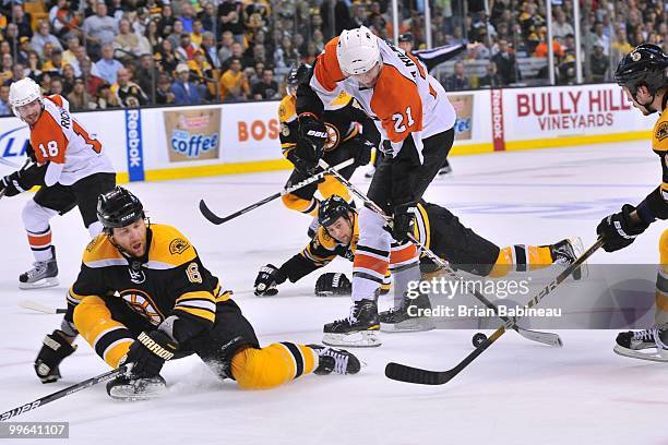 James van Riemsdyk of the Philadelphia Flyers skates with the puck against Dennis Wideman and Marc Savard of the Boston Bruins in Game Seven of the...