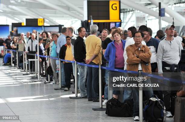 Passengers wait in line for delayed British Airways flights inside Heathrow Airport in London, on May 17, 2010. Britain's conciliation service Acas...