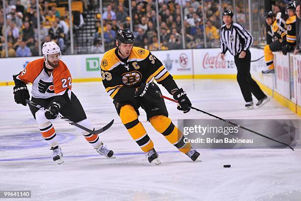 Zdeno Chara of the Boston Bruins skates with the puck against Ville Leino of the Philadelphia Flyers in Game Seven of the Eastern Conference...