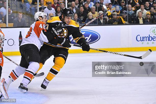 Milan Lucic of the Boston Bruins skates after the puck against Danny Briere of the Philadelphia Flyers in Game Seven of the Eastern Conference...
