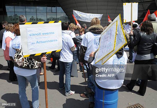 French pharmaceutical giant Sanofi-Aventis employees take part in a demonstration in front of the "Palais des Congres" in Paris where the group's...