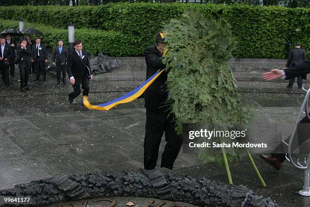 Wreath falls towards the President of Ukraine Viktor Yanukovych during a ceremony to mark the 1932-1933 Soviet famine known as Golodomor on May 17,...