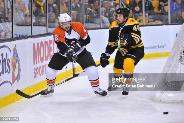Danny Briere of the Philadelphia Flyers passes the puck against Matt Hunwick of the Boston Bruins in Game Seven of the Eastern Conference Semifinals...