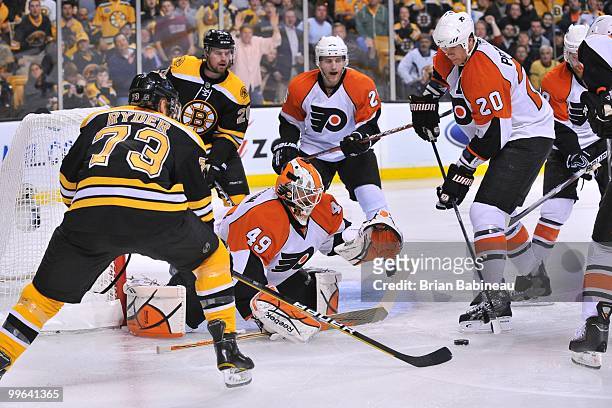 Michael Leighton of the Philadelphia Flyers watches the loose puck against the Boston Bruins in Game Seven of the Eastern Conference Semifinals...