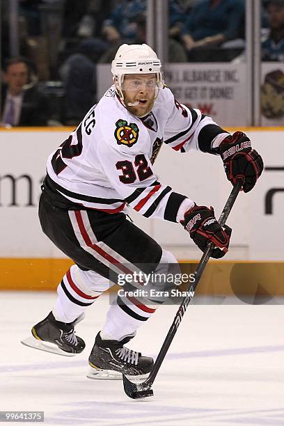 Kris Versteeg of the Chicago Blackhawks moves the puck while taking on the San Jose Sharks in Game One of the Western Conference Finals during the...