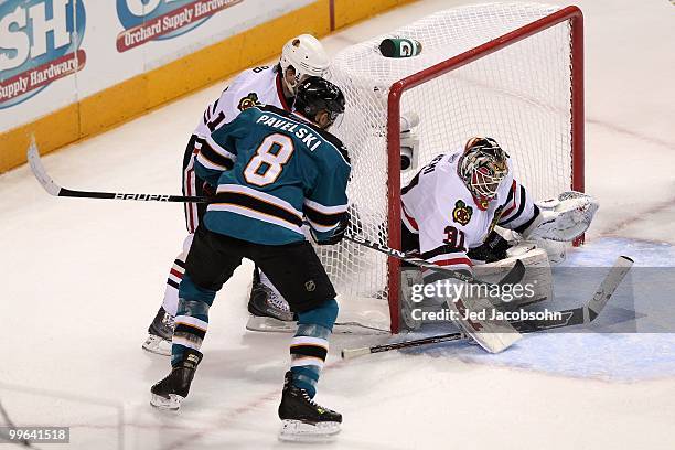 Joe Pavelski of the San Jose Sharks shoots the puck as goaltender Antti Niemi of the Chicago Blackhawks makes a save in Game One of the Western...
