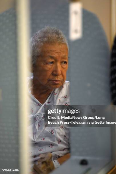 Thomas Kim sits in a hospital gown in a wheelchair as his arraignment is postponed in Superior Court in Long Beach on Monday, July 9, 2018. Kim, the...