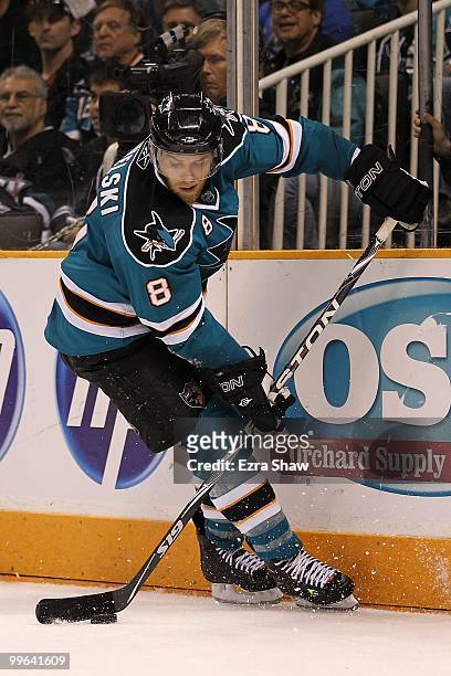Joe Pavelski of the San Jose Sharks moves the puck while taking on the Chicago Blackhawks in Game One of the Western Conference Finals during the...