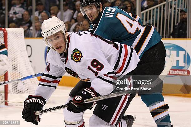 Jonathan Toews of the Chicago Blackhawks goes after the puck in front of Marc-Edouard Vlasic of the San Jose Sharks in Game One of the Western...