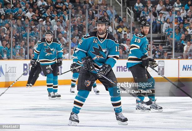 Dany Heatley, Patrick Marleau and Joe Thornton of the San Jose Sharks watch the play against the Detroit Red Wings in Game Five of the Western...