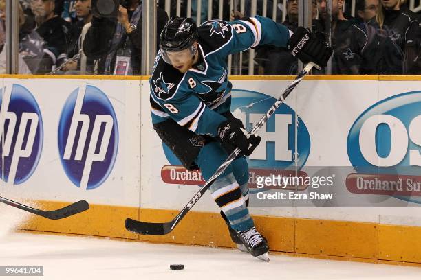 Joe Pavelski of the San Jose Sharks moves the puck while taking on the Chicago Blackhawks in Game One of the Western Conference Finals during the...