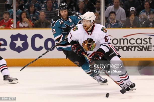 Brian Campbell of the Chicago Blackhawks moves the puck while taking on the San Jose Sharks in Game One of the Western Conference Finals during the...