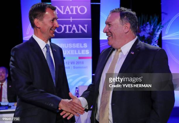 Britain's Secretary of State for Foreign and Commonwealth Affairs Jeremy Hunt and Acting U.S. Secretary of State Mike Pompeo shake hands as they take...