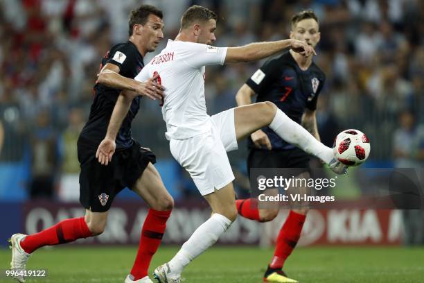 Mario Mandzukic of Croatia, Jordan Henderson of England during the 2018 FIFA World Cup Russia Semi Final match between Croatia and England at the...