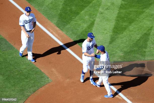 Chris Taylor and manager Dave Roberts of the Los Angeles Dodgers shake hands before the game against the San Francisco Giants at Dodger Stadium on...