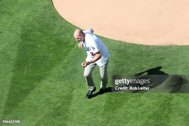 Kirk Gibson reacts after throwing out the first pitch before the game between the San Francisco Giants and the Los Angeles Dodgers at Dodger Stadium...