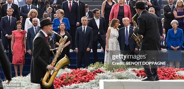 Musicians perform in front of French President Emmanuel Macron, Amelie Derbaudrenghien, partner of Belgian Prime Minister, wife of French President...