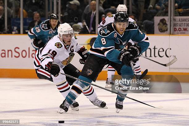 Joe Pavelski of the San Jose Sharks moves the puck in front of Jonathan Toews of the Chicago Blackhawks in Game One of the Western Conference Finals...