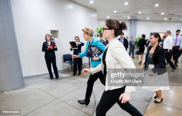 Sen. Elizabeth Warren, D-Mass., runs to catch the Senate subway in the Capitol on Wednesday, July 11, 2018.