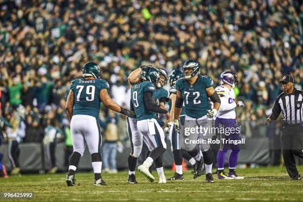 Playoffs: Philadelphia Eagles QB Nick Foles victorious with Brandon Brooks , Halapoulivaati Vaitai , and Stefen Wisniewski after throwing 53-yard...